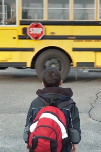 Young child waiting for school bus